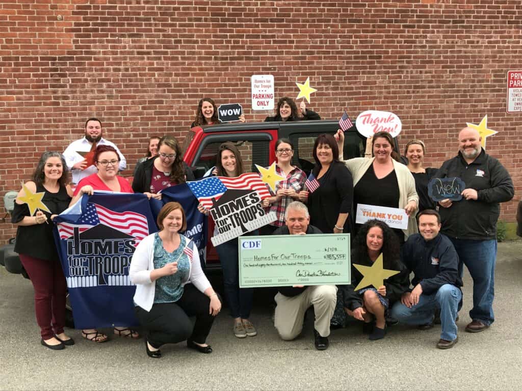 home for our troops receiving a big check from Vehicles For Veterans