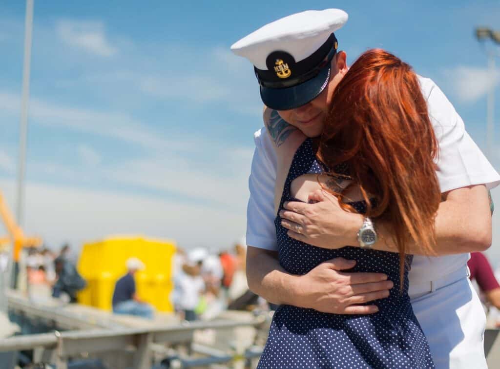 Navy veteran hugging wife