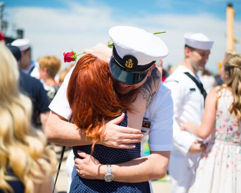 Navy man hugging wife