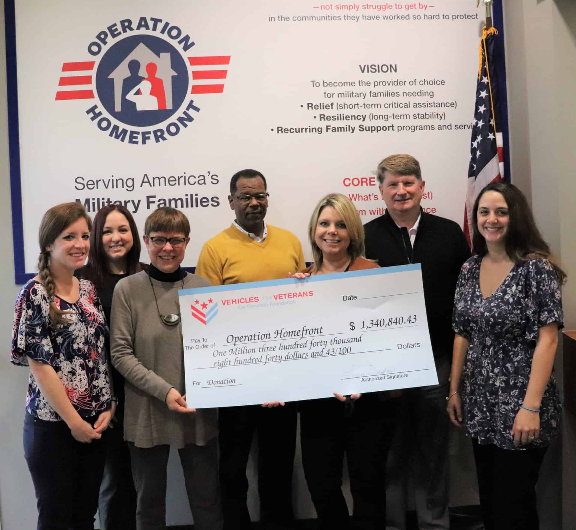 giant check from Vehicles For Veterans to Operation Homefront