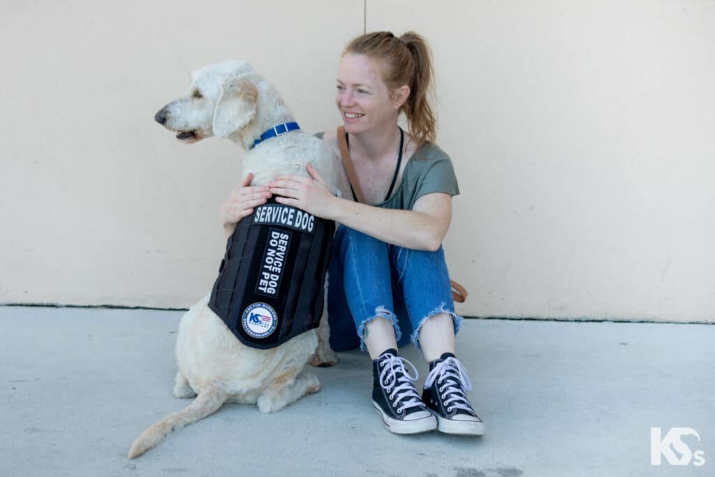 veteran woman smiling with service dog