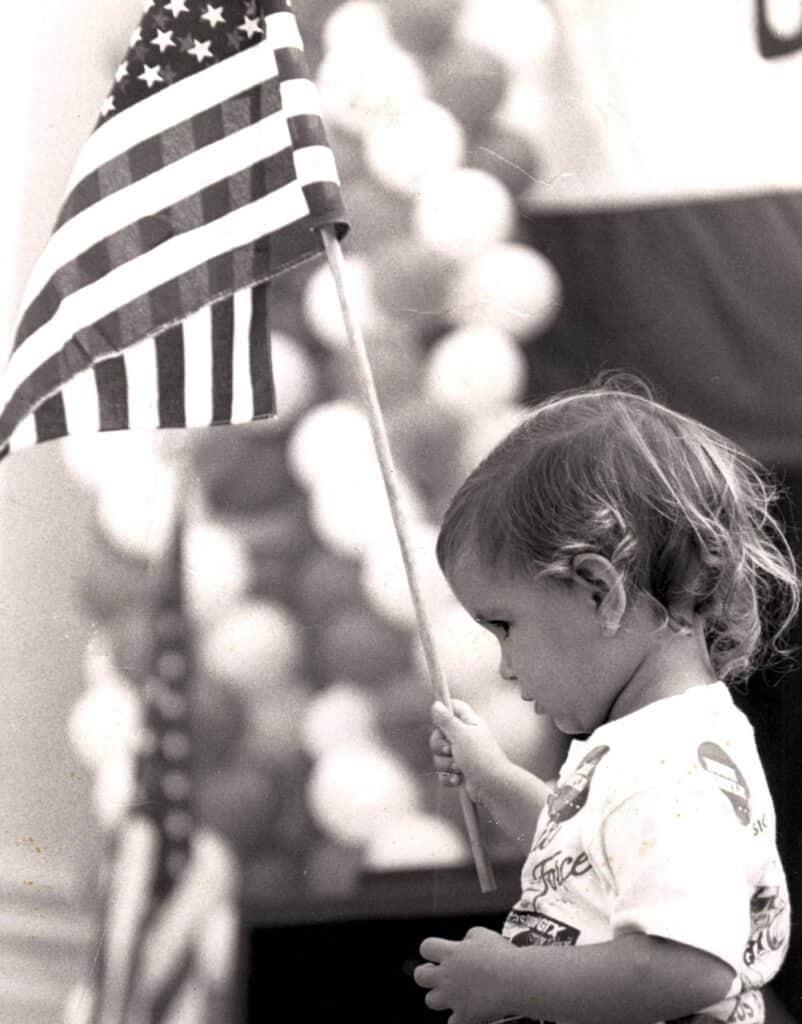 USA child holding American flag in Riverside, California