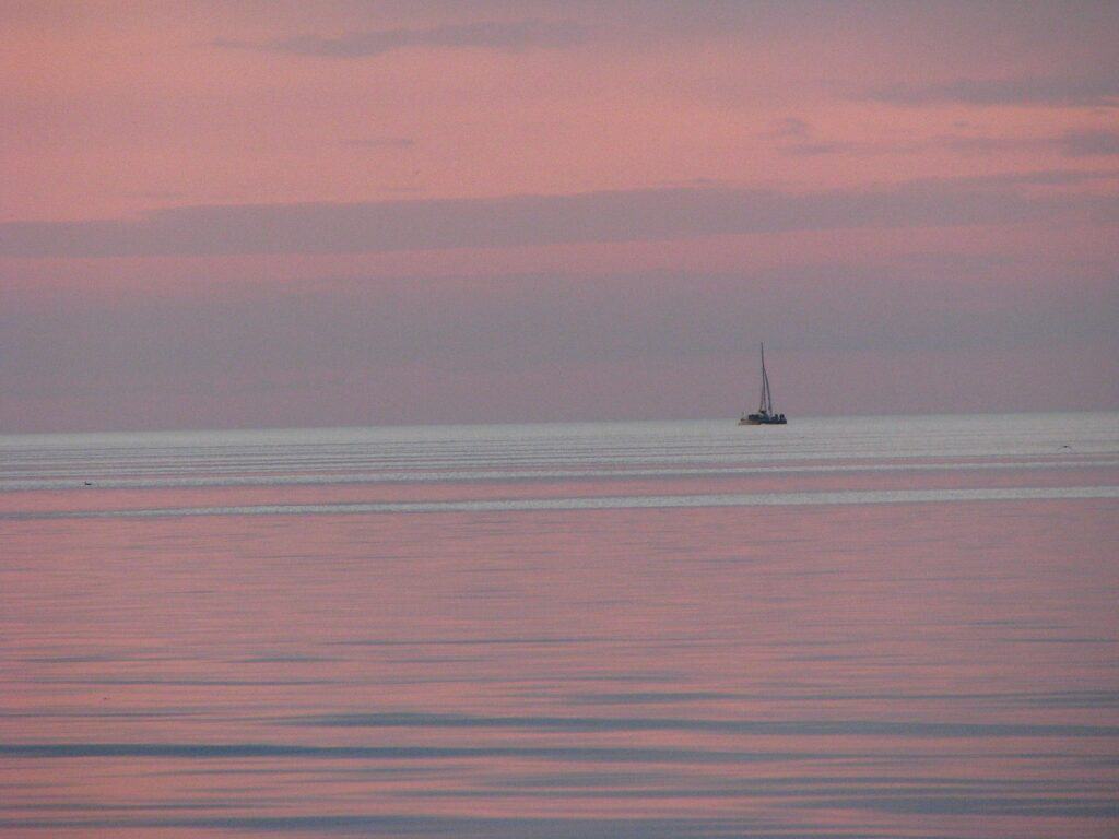 sailboat in the distance, outside on the water, in Rochester, NY