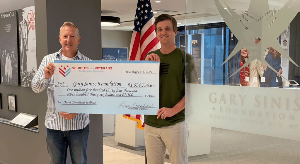 Giant check from Vehicles For Veterans to Gary Sinise Foundation.