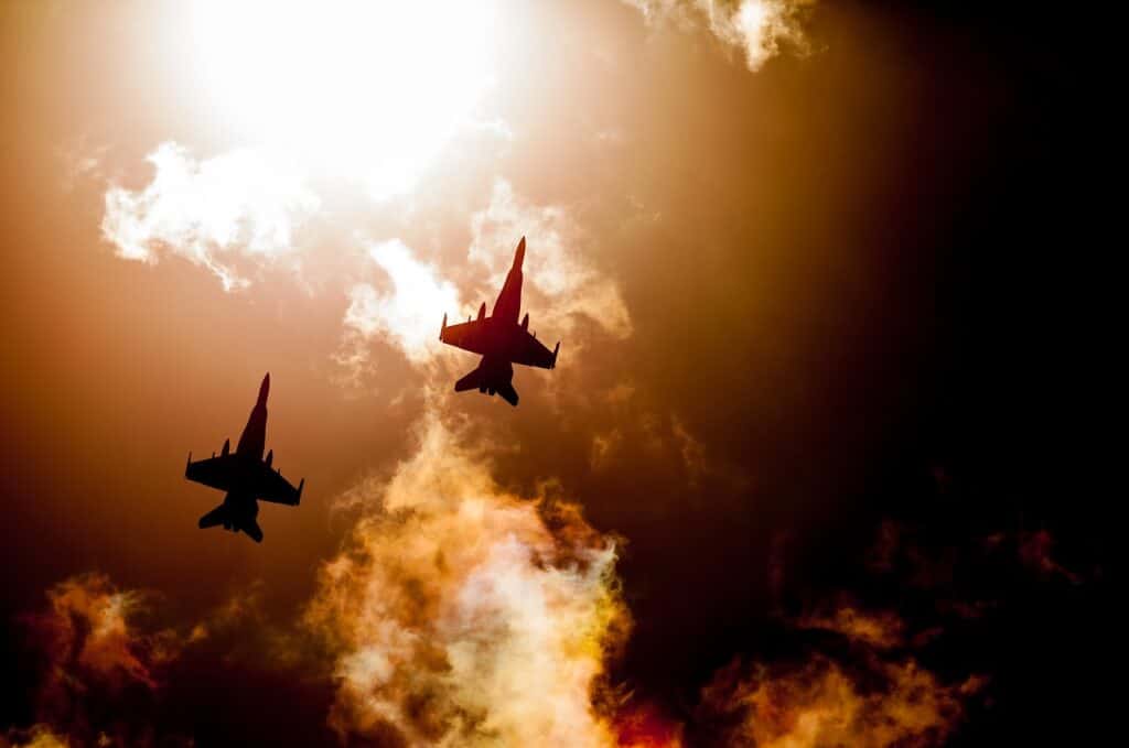 View of looking up at two U.S. jets during a sunrise