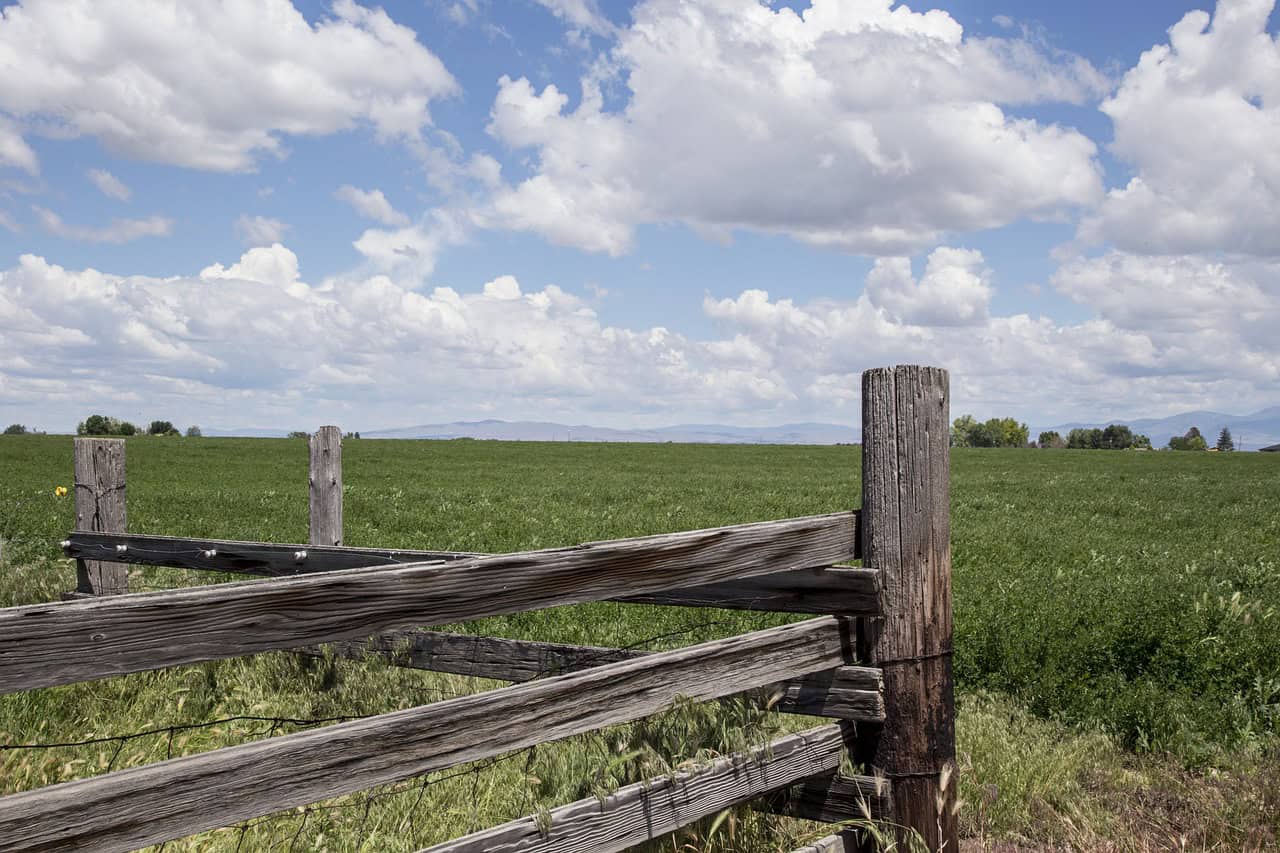 outdoor fence post with grass and beautiful cloudy blue sky in Nampa, Idaho