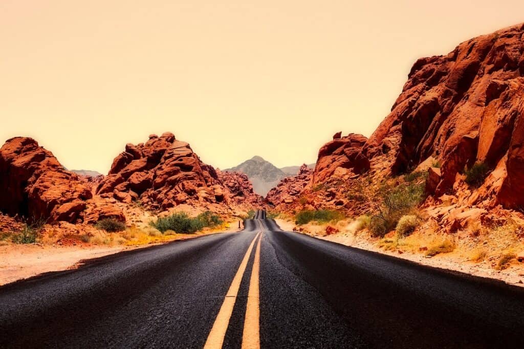 Nevada road during golden hour with desert on both sides