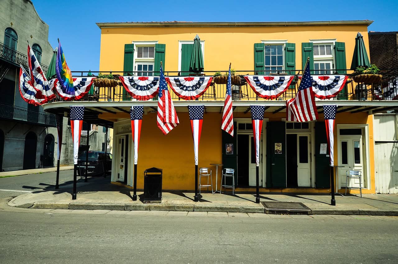 New Orleans home adorned with American flags in daylight